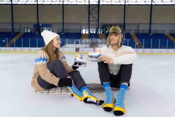 man and woman wearing ice skate socks, funny and colourful gift idea, ice skates socks box