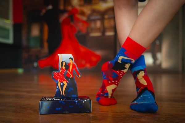 Woman wearing Dance With Me socks for a dancer, red-blue socks featuring couple of dancers, Rainbow Socks