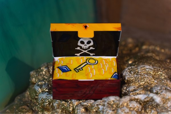 Yellow cotton socks with a pirate treasure patterns, socks in a treasure chest