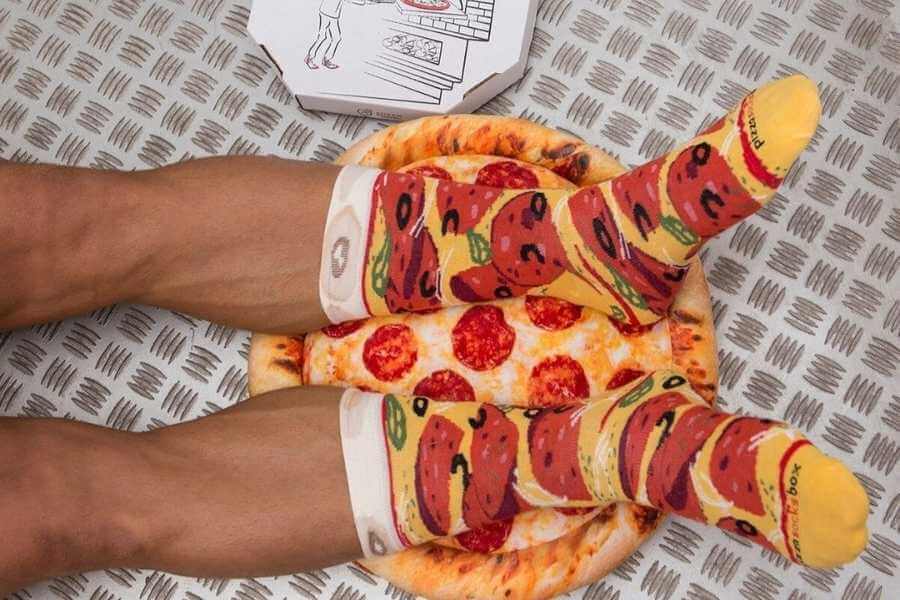 Legs with pizza socks on, pizza image and a box