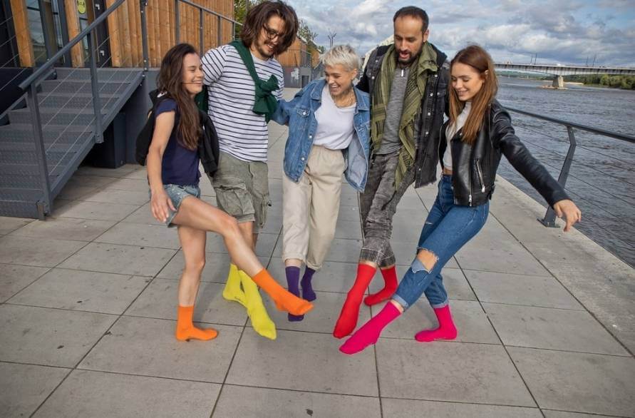 A group of friends wearing colourful cotton crew socks