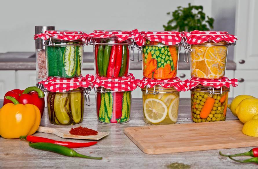 Eight jars of Rainbow fruit socks on a kitchen worktop