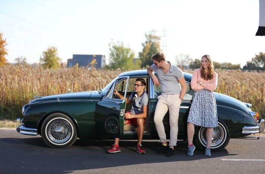 Fashion Socks – group of stylish friends wearing Rainbow Socks next to a vintage car