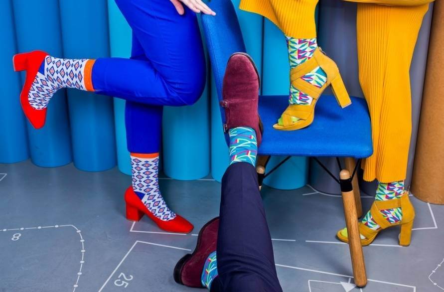 Businessman and Businesswoman wearing colourful geometric socks