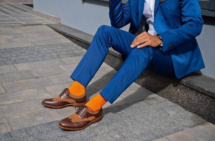 Rainbow Silitex Socks – Man in suit in his orange Silitex Crew Socks.